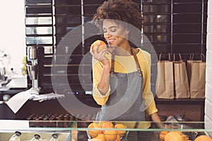 Happy mulatto girl is working in organic food store