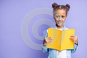 Happy mulatto school child with book isolated