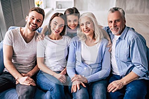 The happy multi generation family sitting on the sofa.