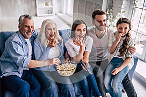 The happy multi generation family watching a tv.