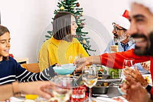 Happy multi generational family gathering at christmas dinner photo