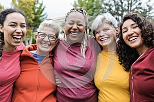 Happy multi generational women having fun together after sport workout outdoor - Focus on african senior woman face