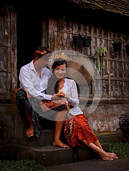 Happy multicultural couple. Romantic concept. Couple in love. Bamboo house. Caucasian wife and Balinese husband wearing