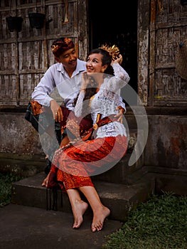 Happy multicultural couple. Romantic concept. Couple in love. Bamboo house. Caucasian wife and Balinese husband wearing