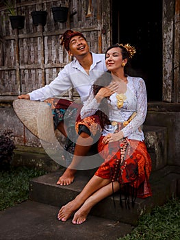 Happy multicultural couple. Romantic concept. Couple in love. Bamboo house. Caucasian wife and Balinese husband wearing