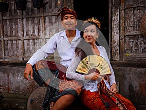 Happy multicultural couple. Romantic concept. Couple in love. Bamboo house. Caucasian wife and Balinese husband wearing