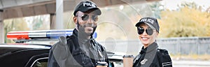 Happy multicultural police officers with paper photo