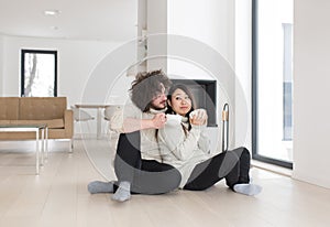 Happy multiethnic couple in front of fireplace