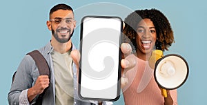 Happy Multiethnic Couple Making Announcement With Megaphone And Showing Blank Smartphone