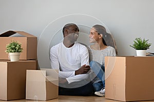 Happy multiethnic couple moving to new home together