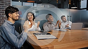 Happy multiethnic employees in office listen training diverse business people multinational team in boardroom applaud