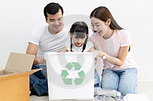 Happy multiethnic family siblings having funsorting segregating household waste at home.Lifestyle - ecological education and