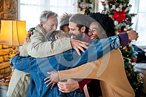 Happy multiethnic multi-generational family enjoying Christmas time together. People love concept.