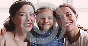 Happy multigeneration women looking at camera, family portrait