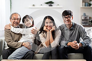 Happy multigenerational asian family portrait in living room