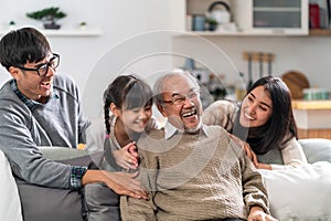 Happy multigenerational asian family portrait in living room