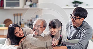 Happy multigenerational asian family portrait in living room panorama