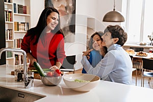 Happy multigenerational family cooking together in kitchen at home