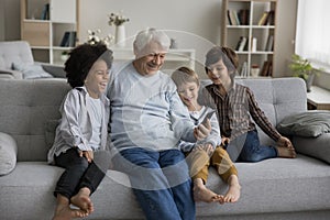 Happy multigenerational family enjoy videocall using smartphone