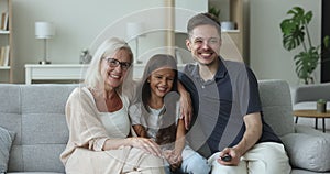 Happy multigenerational family enjoy weekend time watching TV at home