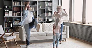 Happy multigenerational family having fun dance together in living room