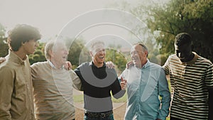 Happy multigenerational group of men with different ethnicities having fun in a public park