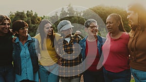 Happy multigenerational group of women with different ethnicities having fun in a public park