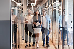 Happy multinational corporate business team stand in office hallway photo