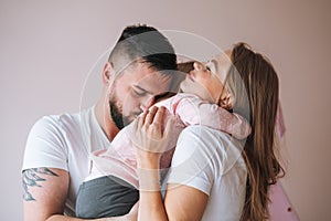 Happy multinational family father young man and mother with baby girl little daughter having fun in children room at home