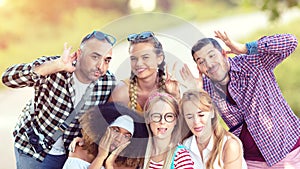 Happy multiracial best friends taking selfie outdoor with funny faces