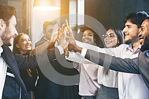 Happy multiracial business team giving high fives