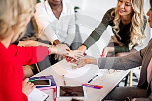 Happy multiracial business women celebrate success or expressing aproval in office