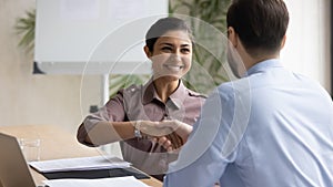 Happy multiracial businesspeople handshake closing deal at meeting