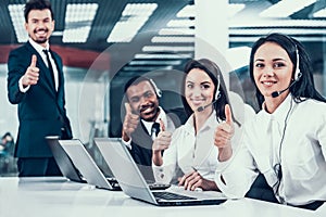 Happy multiracial call center team shows thumbs up