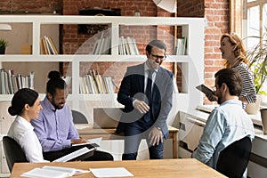 Happy multiracial colleagues have fun at office meeting