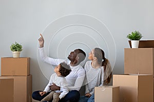 Happy multiracial family have fun moving to new home