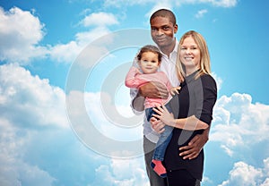 Happy multiracial family with little child