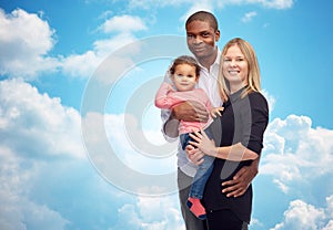 Happy multiracial family with little child photo