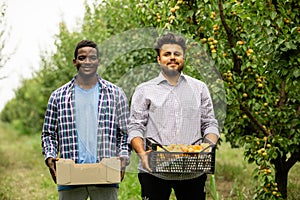 Happy multiracial family in their fruit garden