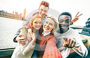 Happy multiracial friends group taking selfie in London city photo