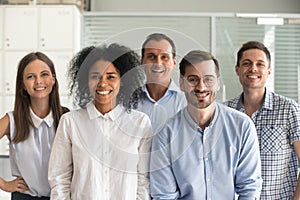 Happy multiracial professional employees looking at camera, team