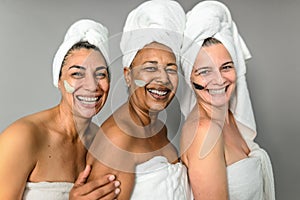 Happy multiracial senior women having skin care spa day