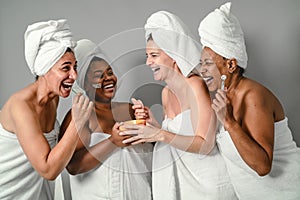 Happy multiracial women with different age and body size having skin care spa day