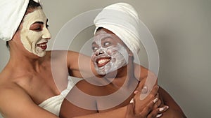 Happy multiracial women with different age and body size having skin care spa day