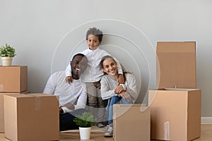 Happy multiracial young family moving to new home together