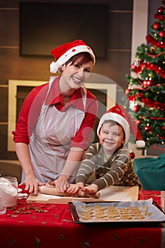 Happy mum baking with son for christmas