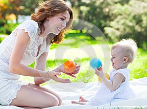 Happy mum and her Child playing in Park together