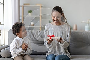 Happy mum holding gift from child son on mothers day