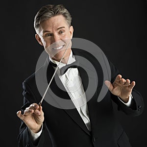 Happy Music Conductor Gesturing While Directing With His Baton