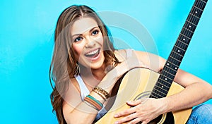 Happy musician woman portrait with guitar